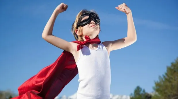 nen amb confiança vestit de superheroi