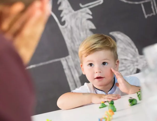 child whispering to the father