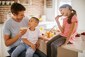 father calmly talking with his children